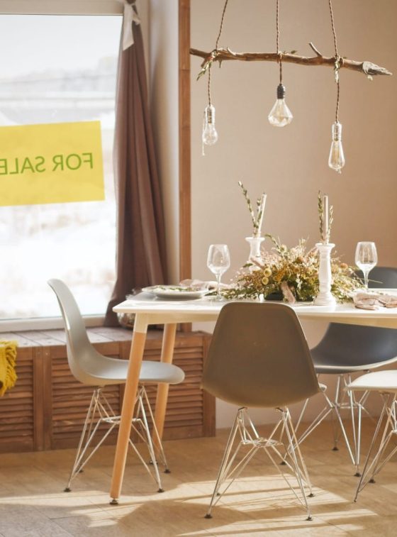 Cover image of the article: Capital Gains tax - Everything You Need to Know - an image of a living room with a window to the outside with a sign saying "For Sale".